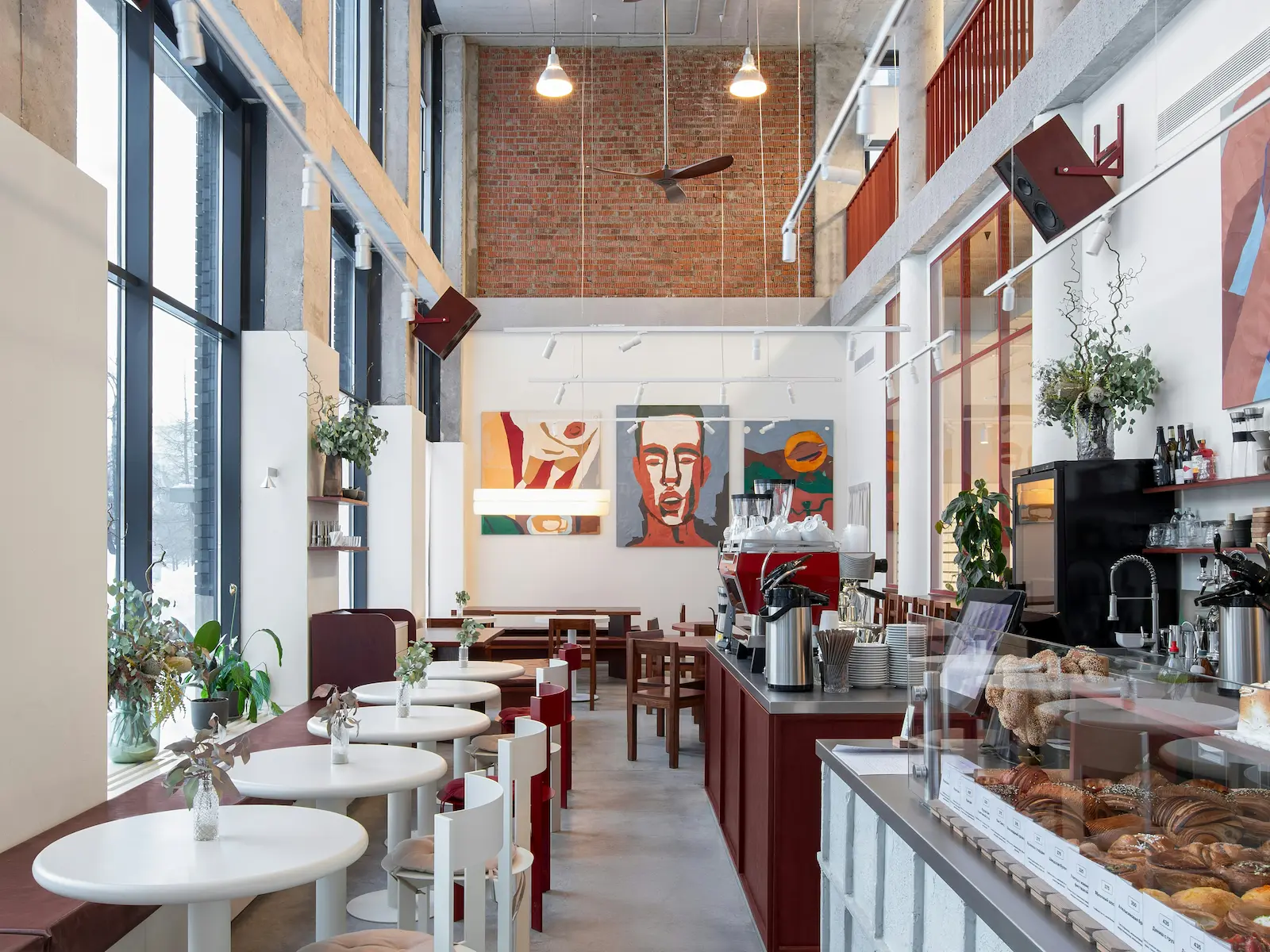 Warm coffee shop interior with fresh pastries, espresso bar, and indoor seating.